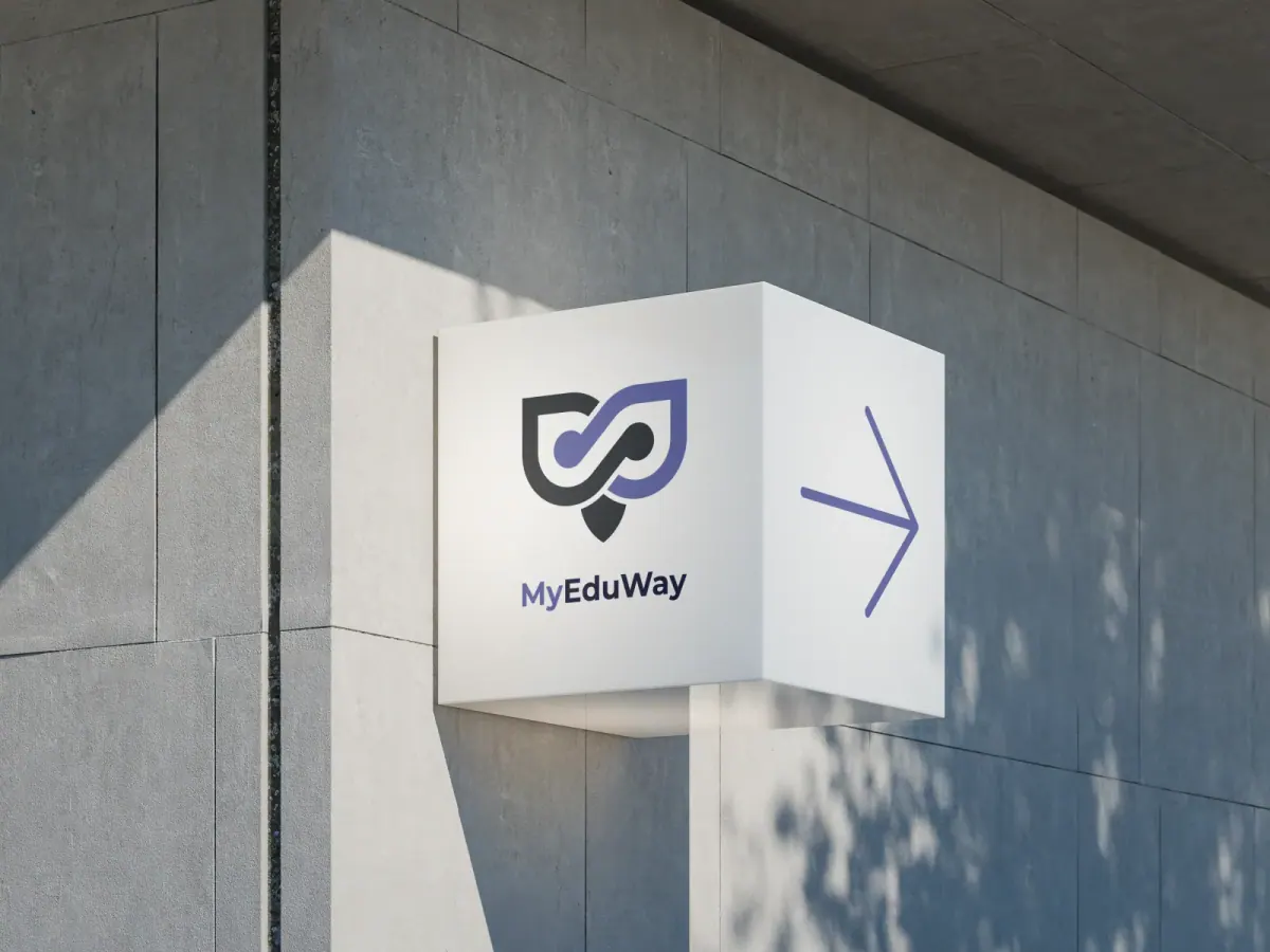 Narożny szyld z logo MyEduWay i strzałką na jasnej betonowej ścianie